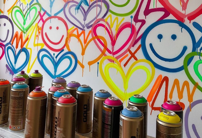 spray paint cans and art on wall